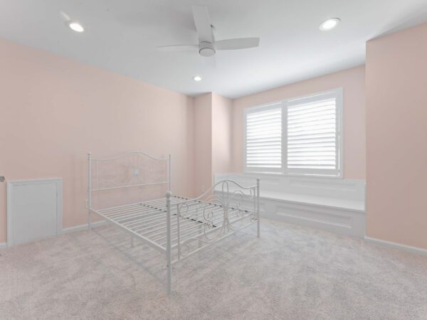 Modern bedroom in Bucks County, PA with light pink walls, carpet, recessed lighting, and ceiling fan.